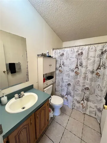 a bathroom with a sink toilet mirror and shower