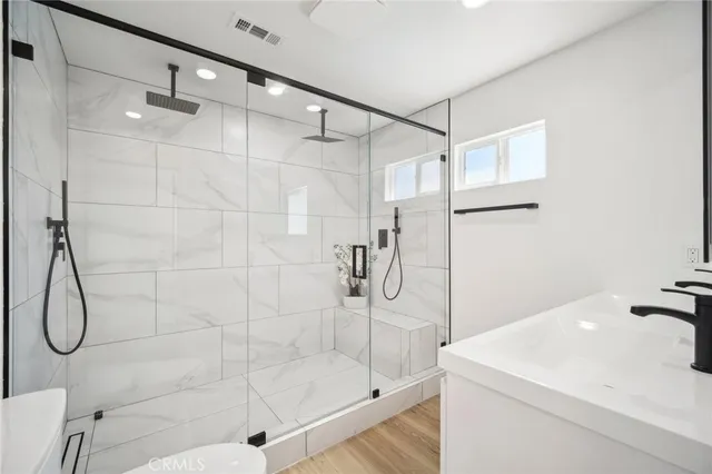 a large white bed sitting in a bedroom next to a window