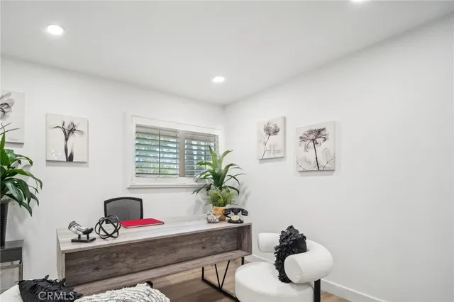 a living room with furniture potted plant and a window