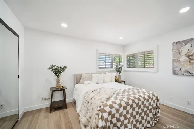 a bedroom with a large bed and a window