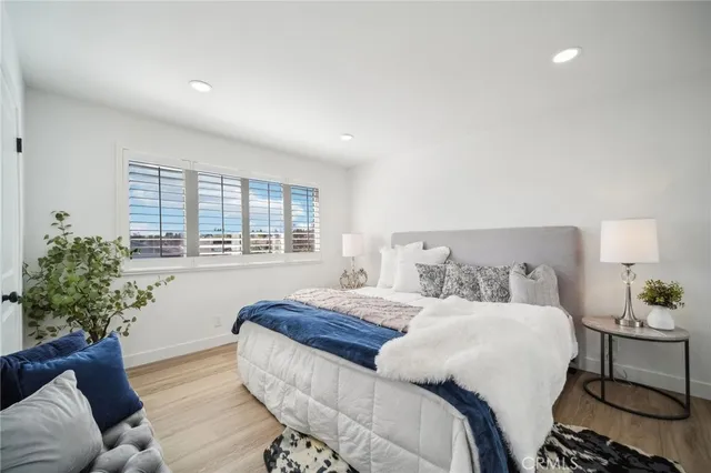 a bedroom with a bed and a lamp