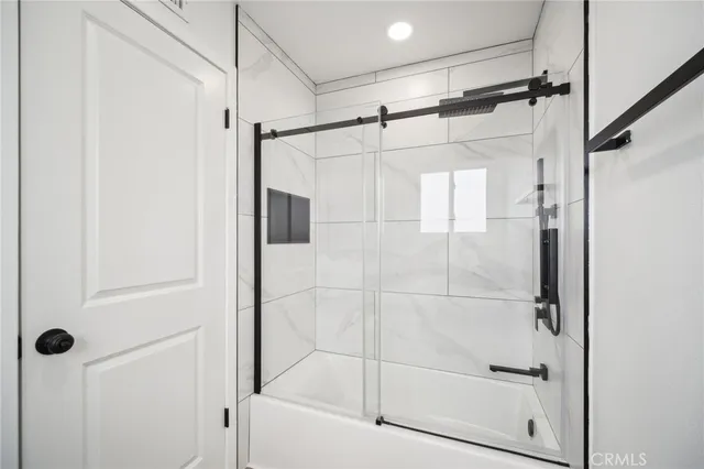 a patio with a table and chairs and potted plants