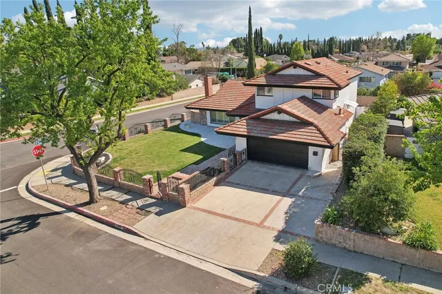 an aerial view of a house with a swimming pool