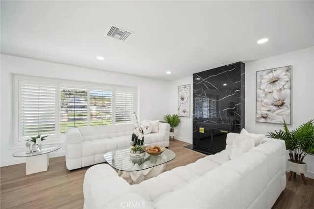 a living room with furniture potted plant and a couch
