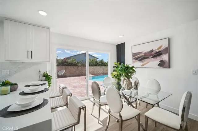 a kitchen with white cabinets stainless steel appliances and kitchen island