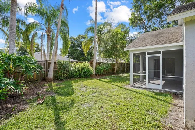 a view of a house with backyard and garden