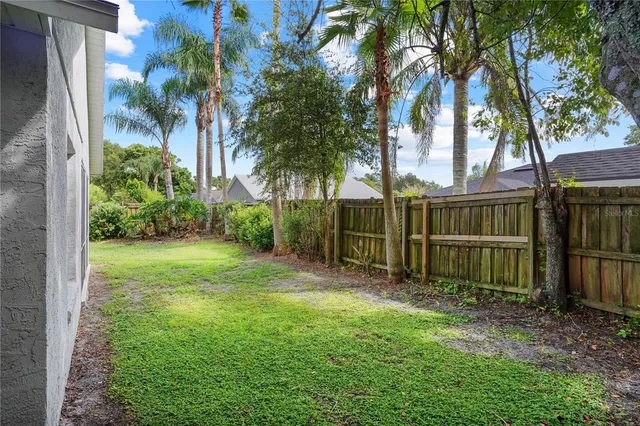 an aerial view of a houses with a yard