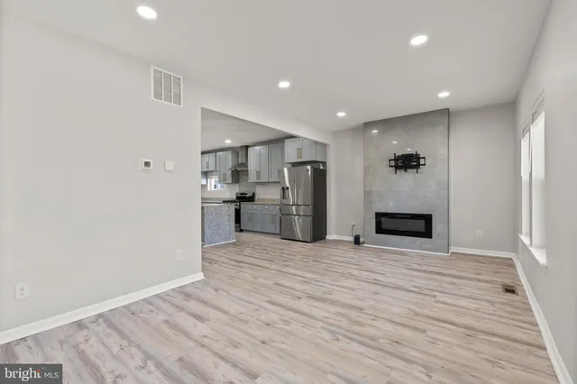 a view of a kitchen with a sink and a refrigerator
