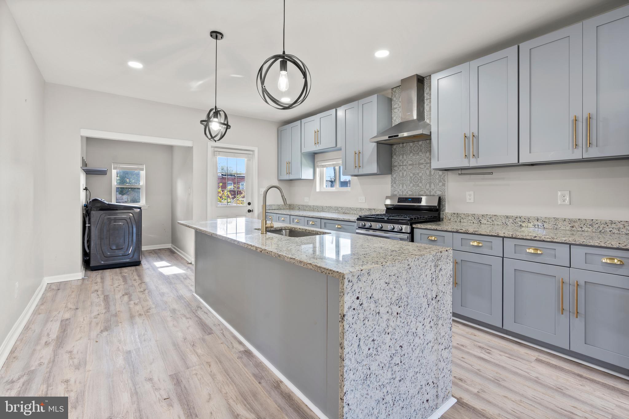 3809 West Cold Spring Lane Baltimore, MD 21215 - Photo 15 of 47 a kitchen with cabinets a sink and appliances