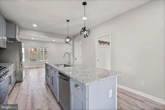 a kitchen with a stove and a wooden floor