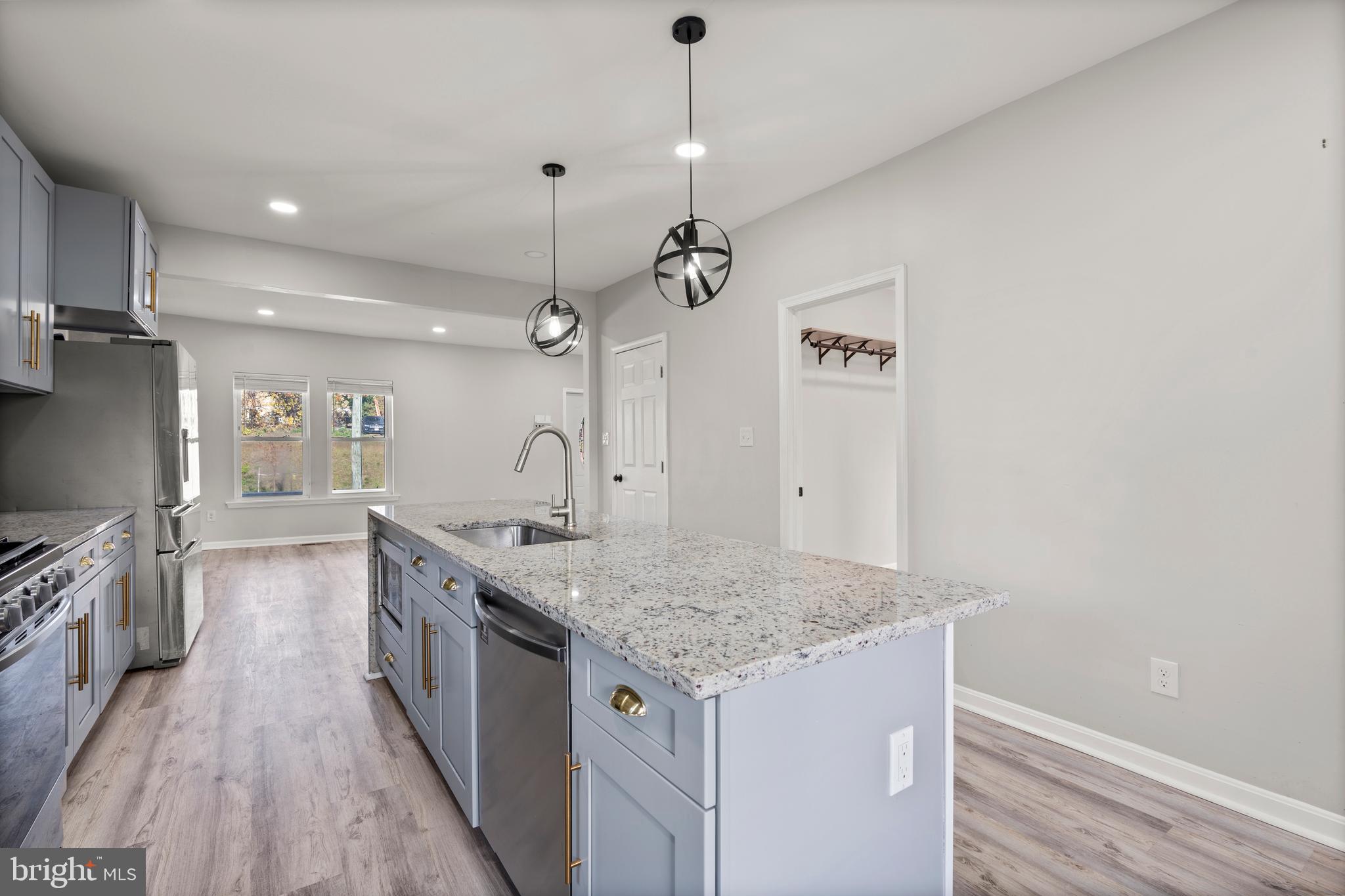 3809 West Cold Spring Lane Baltimore, MD 21215 - Photo 18 of 47 a kitchen with a stove and a wooden floor