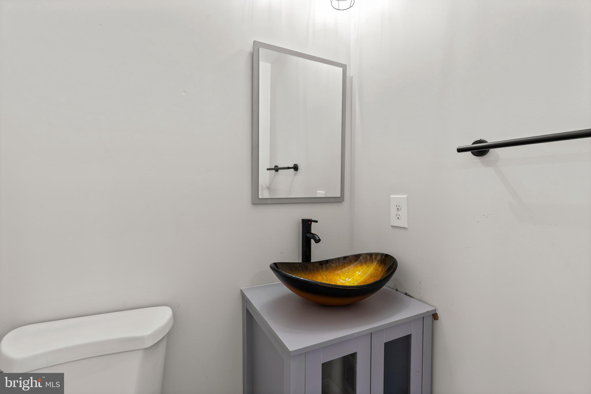 3809 West Cold Spring Lane Baltimore, MD 21215 - Photo 20 of 47 a bathroom with a toilet and a sink