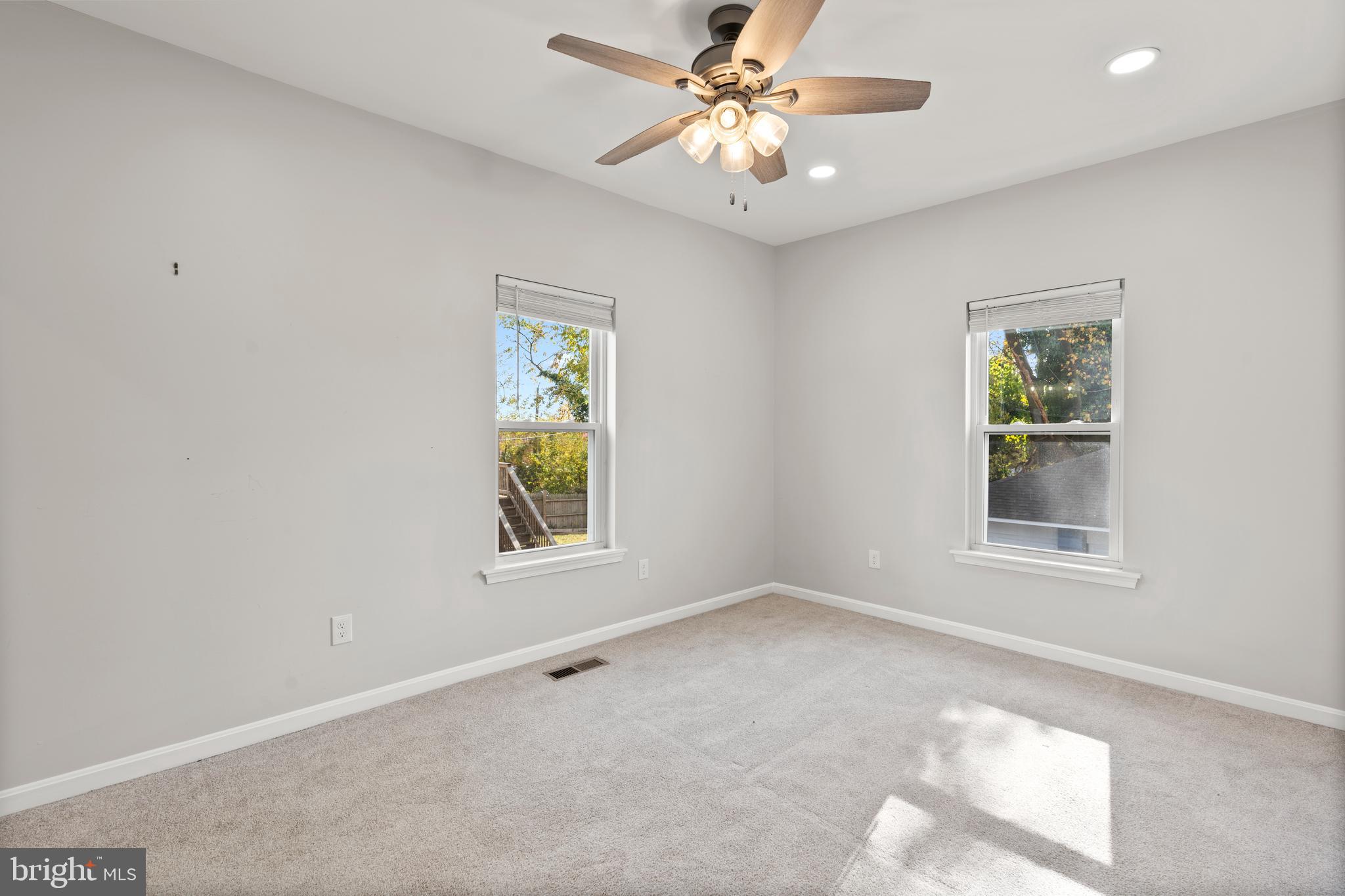 3809 West Cold Spring Lane Baltimore, MD 21215 - Photo 21 of 47 an empty room with windows and fan
