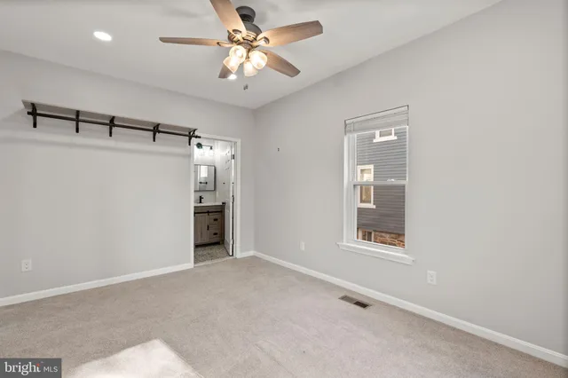 a view of a big room with chandelier fan and windows