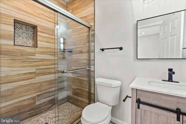 a bathroom with a toilet a sink and shower