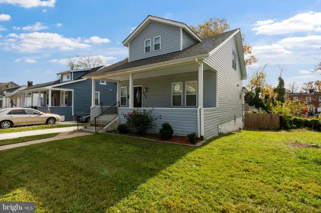 a view of a house with a big yard and potted plants