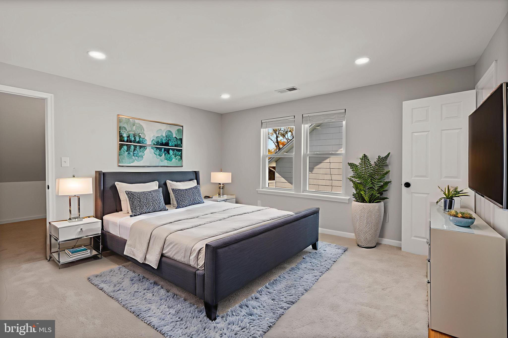 3809 West Cold Spring Lane Baltimore, MD 21215 - Photo 35 of 47 a bedroom with a large bed a potted plant and a window