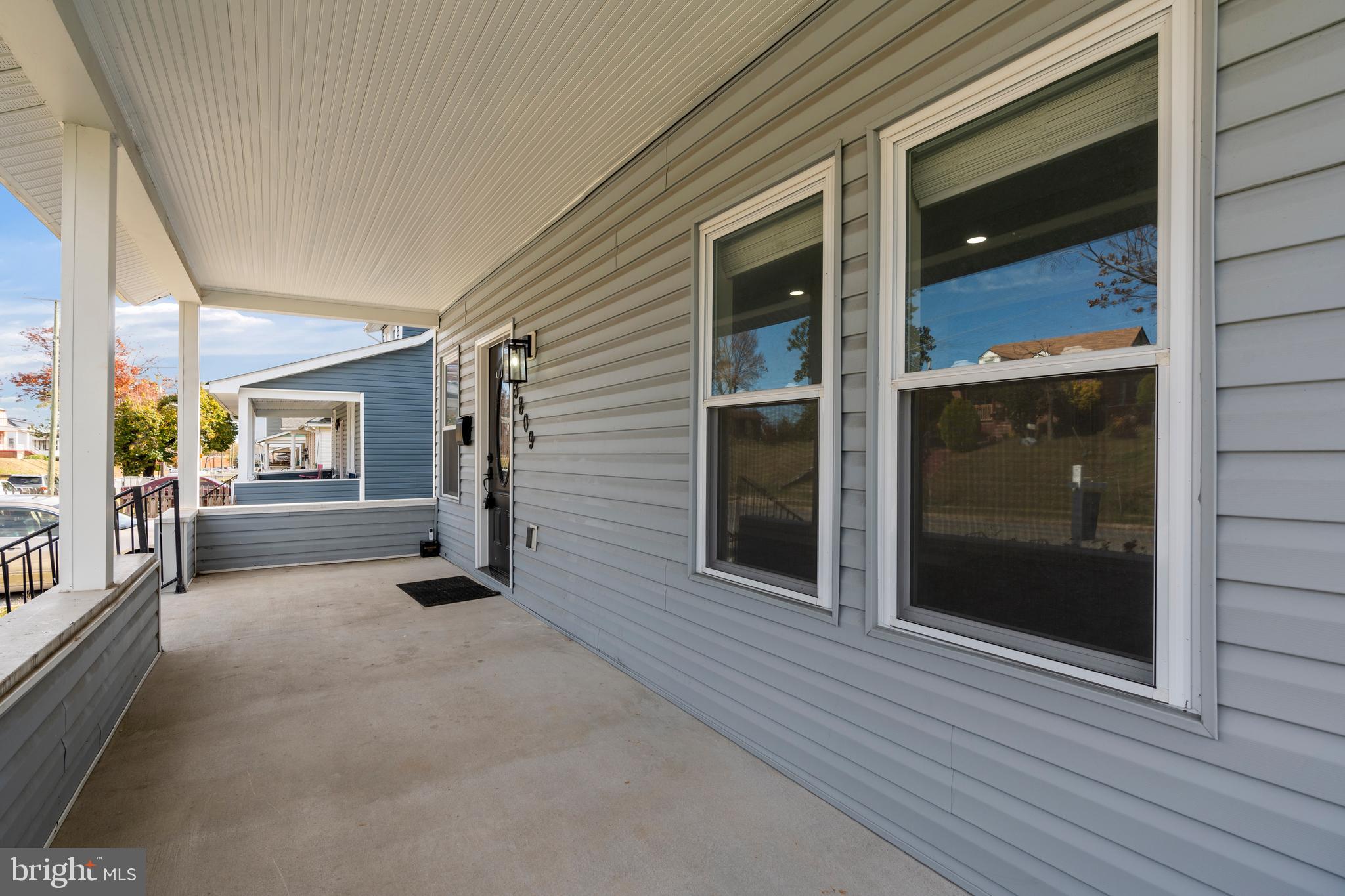 3809 West Cold Spring Lane Baltimore, MD 21215 - Photo 6 of 47 a view of a hallway with wooden floor and a window