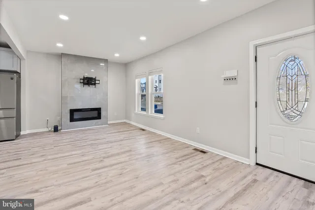 a view of empty room with wooden floor