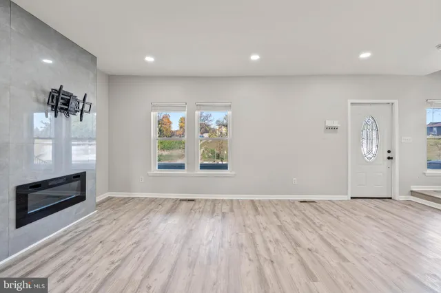 wooden floor in an empty room with a window