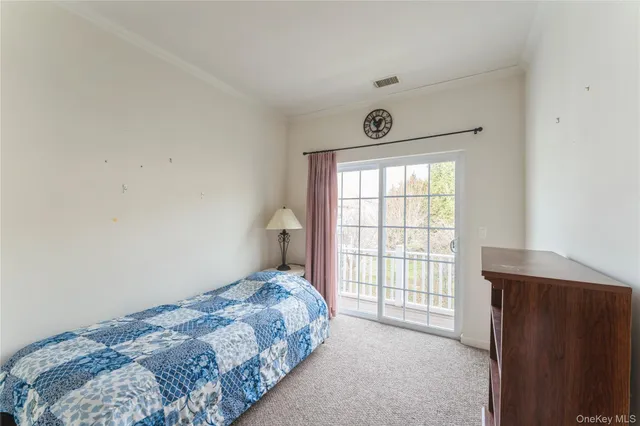 a bedroom with a bed and a lamp