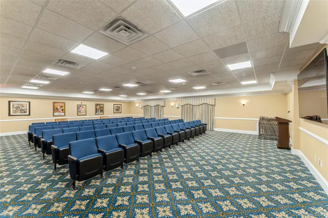 a front view of a house with a garden and trees