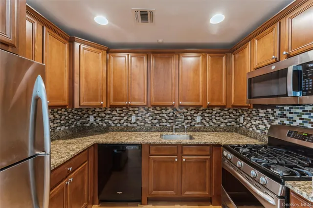 a kitchen with wooden cabinets and a stove top oven