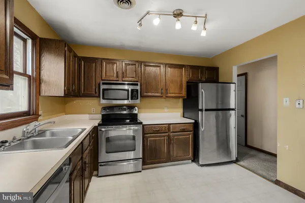 a kitchen with a refrigerator sink and stove