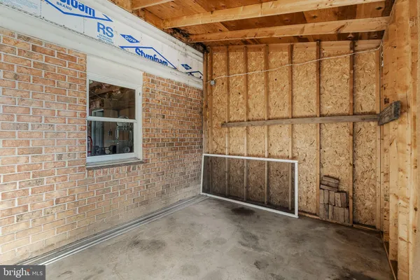 a view of hallway with wooden walls