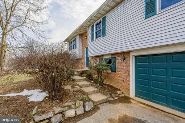 a view of house with backyard and sitting area