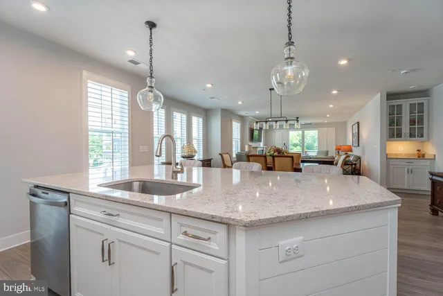 a large kitchen with granite countertop a stove and a sink