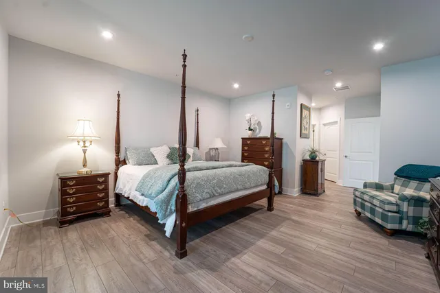 a spacious bedroom with a bed a table and chairs