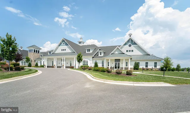a front view of a house with a garden and plants