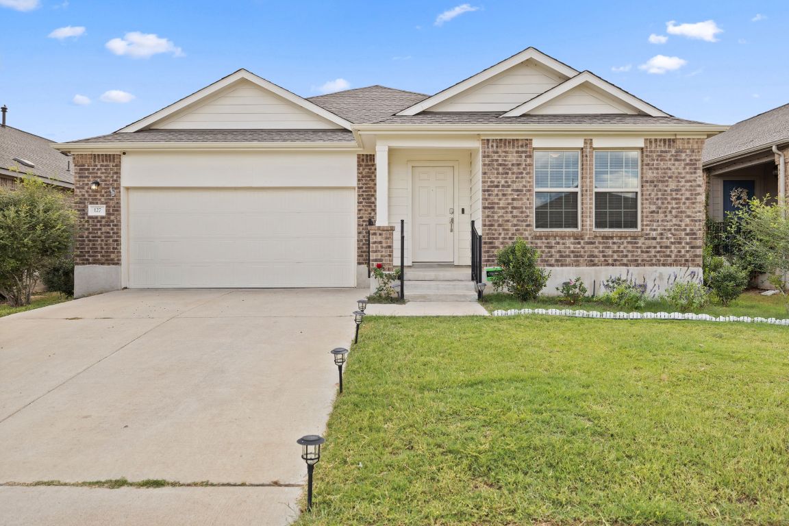 a front view of a house with garden