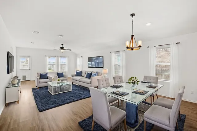 a view of a room with wooden floor and window
