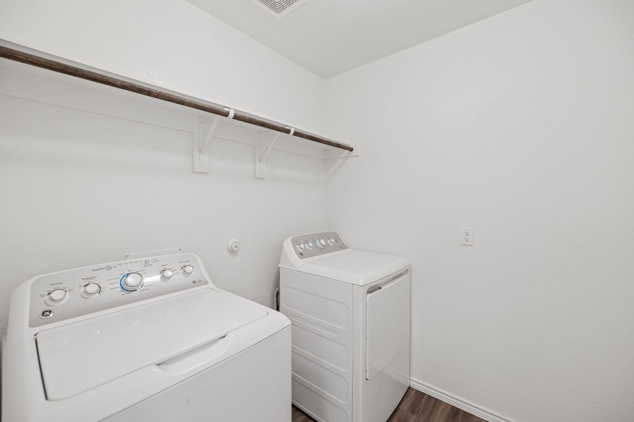 127 George Kimble Cove Bastrop, TX 78602 - Photo 21 of 40 Washroom with dark wood-type flooring and separate washer and dryer