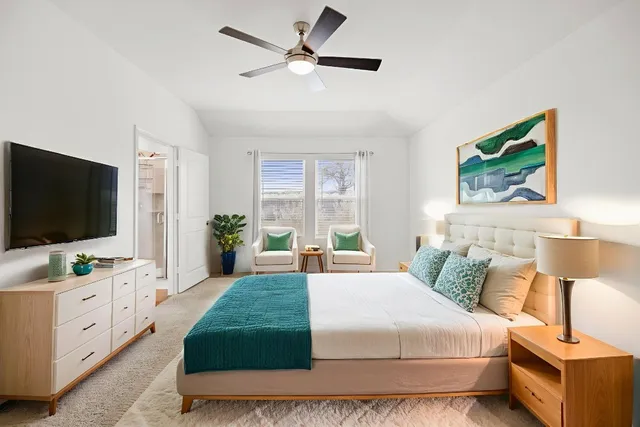 a bedroom with a bed and a flat screen tv