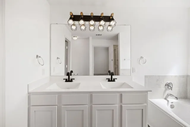 a bathroom with a sink vanity and a mirror