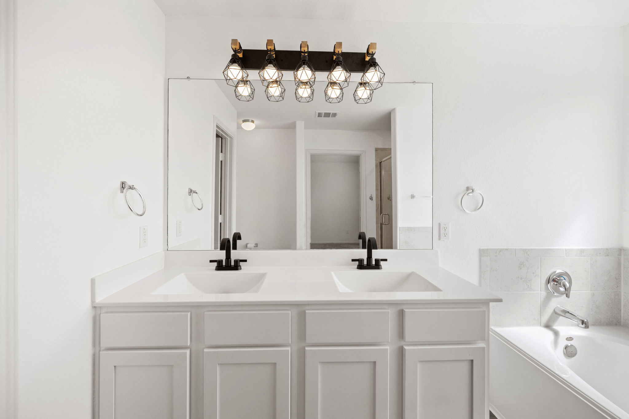 127 George Kimble Cove Bastrop, TX 78602 - Photo 31 of 40 Bathroom with double vanity and a bath