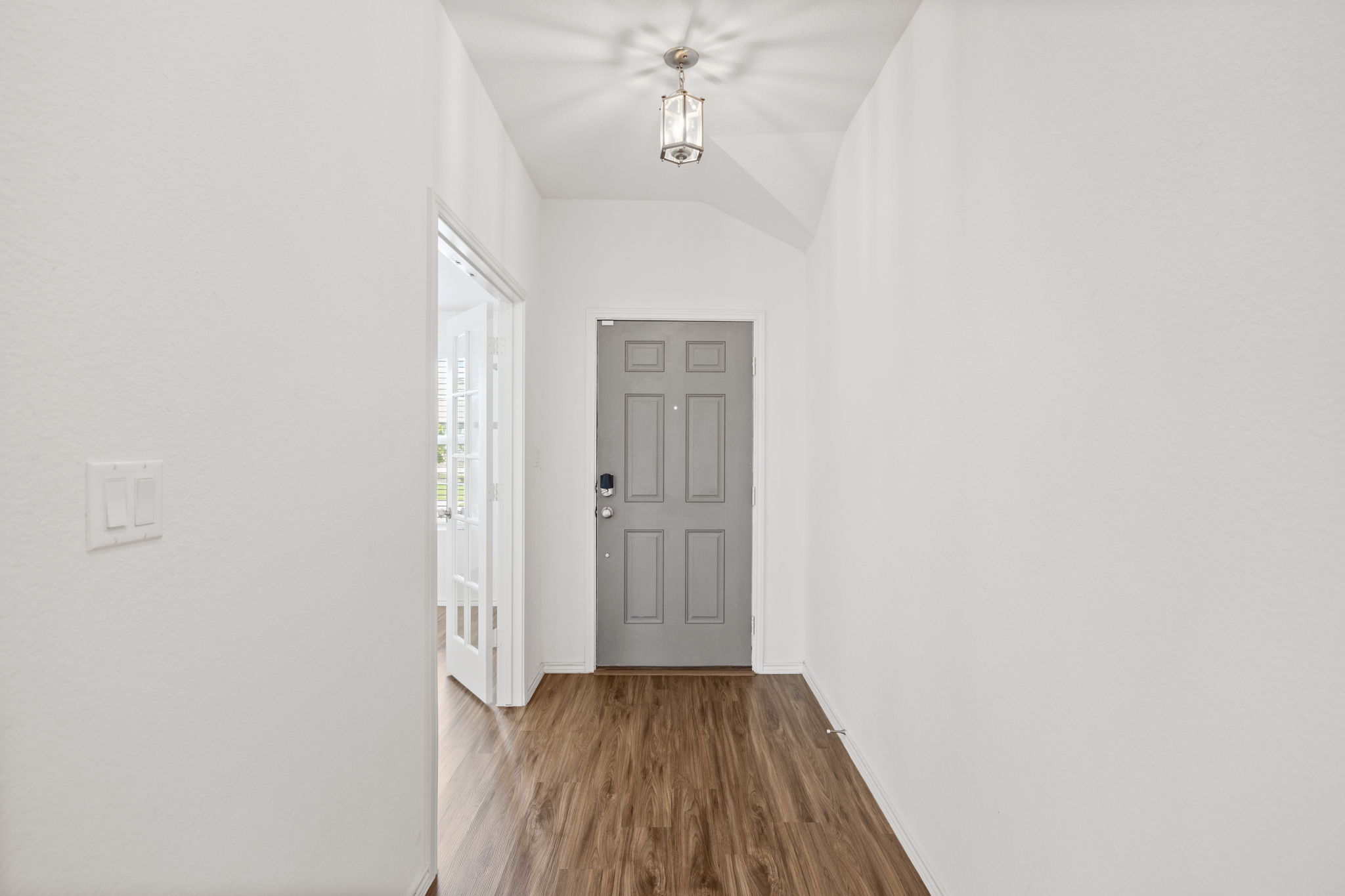 127 George Kimble Cove Bastrop, TX 78602 - Photo 5 of 40 Entryway featuring wood finished floors and lofted ceiling