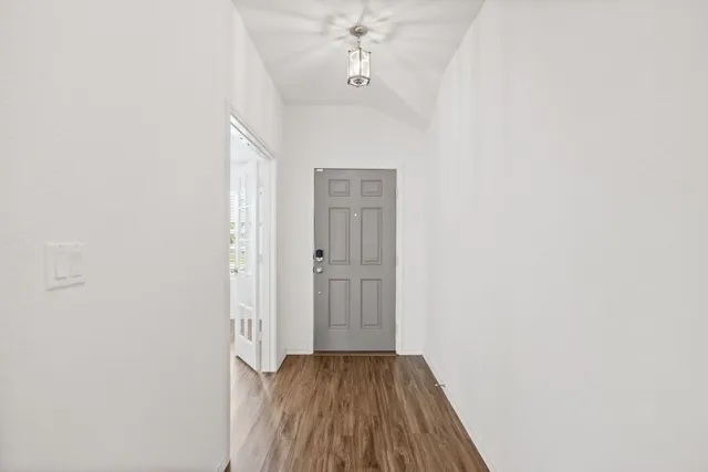 a view of a room with wooden floor