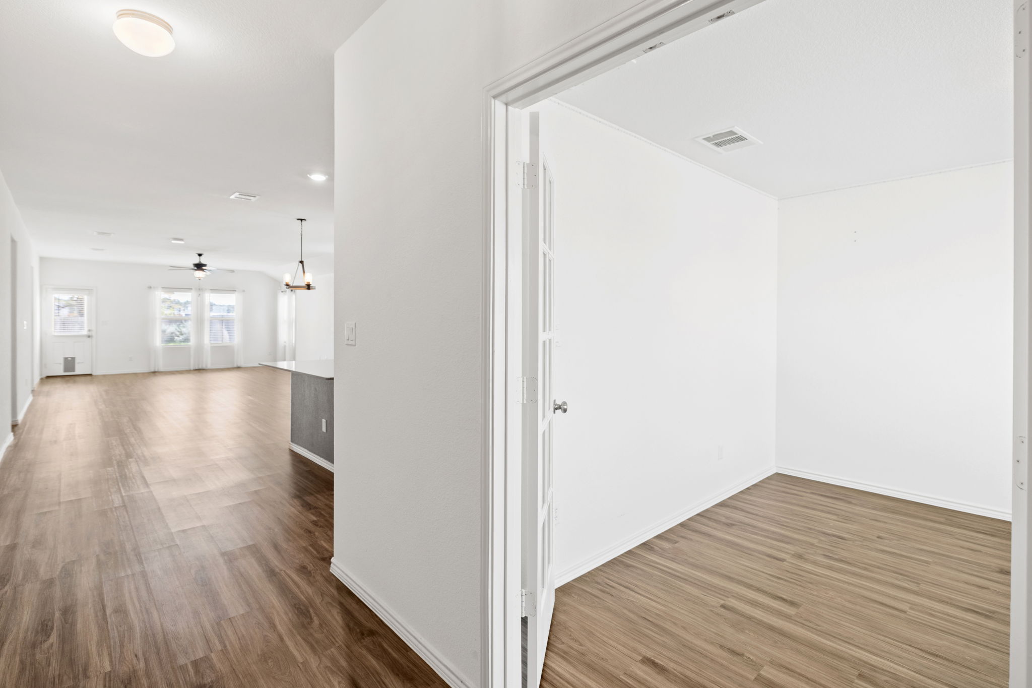 127 George Kimble Cove Bastrop, TX 78602 - Photo 6 of 40 Hall with dark wood-style flooring and a chandelier