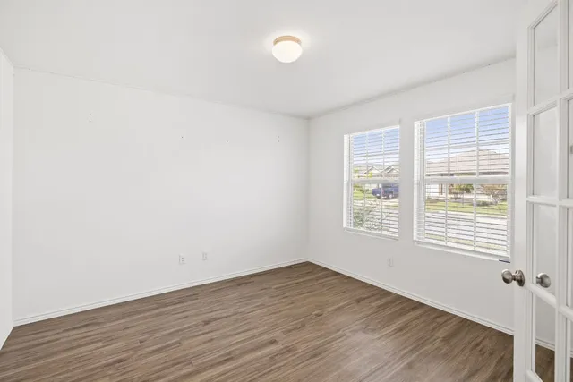 a view of a workspace with furniture and a bookshelf