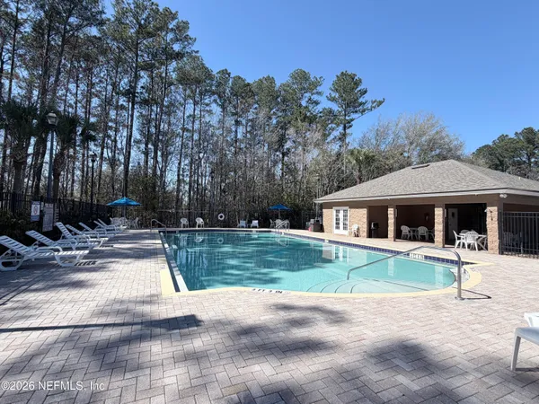 a view of a house with backyard and trees