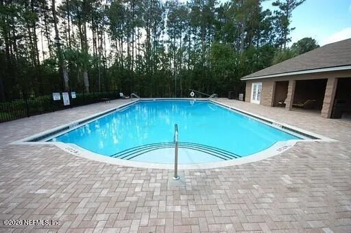 a view of a house with swimming pool and porch with furniture