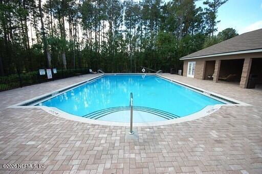7920 Merrill Road, Unit 1811 Jacksonville, FL 32277 - Photo 14 of 15 a view of a swimming pool with a yard