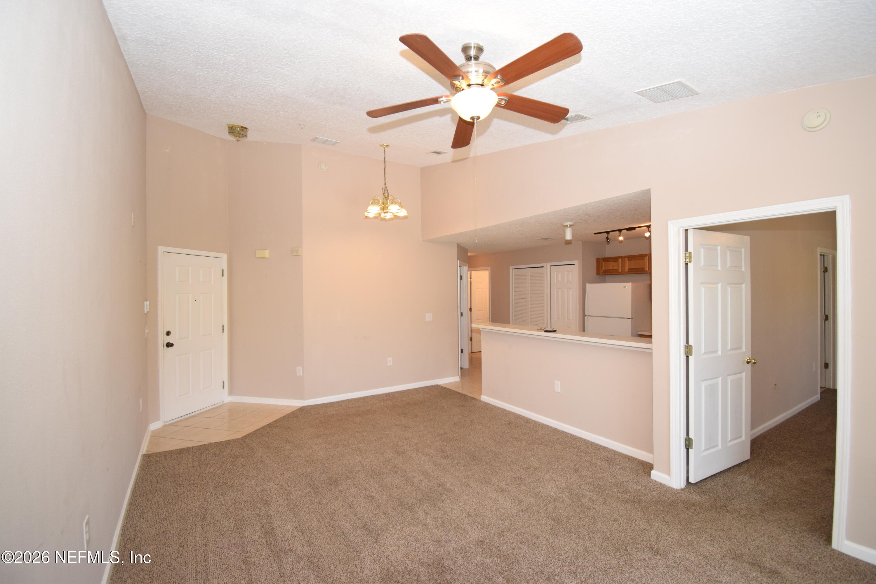 7920 Merrill Road, Unit 1811 Jacksonville, FL 32277 - Photo 2 of 15 an empty room with closet and windows