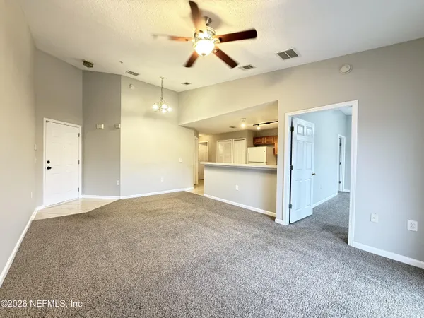 a view of an empty room with a ceiling fan