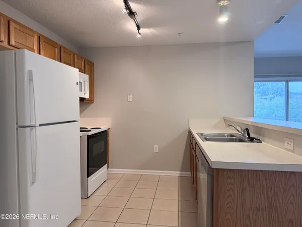 a white refrigerator freezer sitting inside of a kitchen