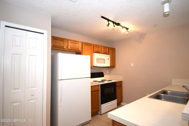 a kitchen with a refrigerator and a sink